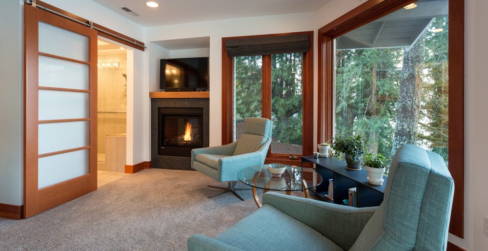 This bedroom remodel resulted in a lovely sitting room that takes advantage of forest views.