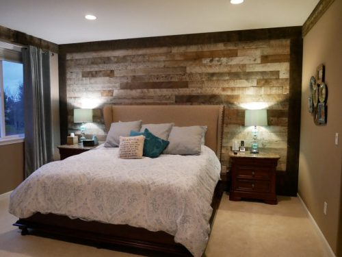 The wooden focus wall in this bedroom remodel offers a personal touch to the space.