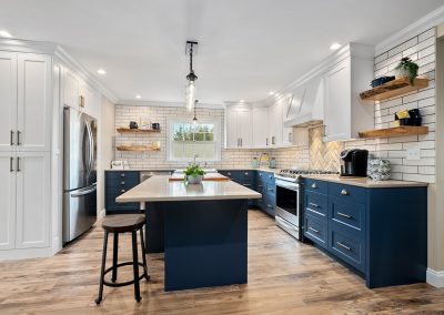Home remodeling: Blue cabinets and white walls in a freshly updated kitchen.